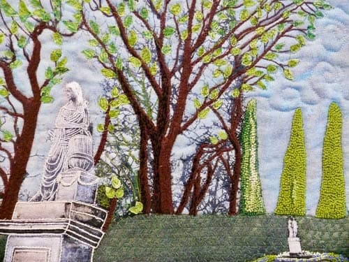 Artwork: This Garden of Schoenbrunn Palace in Vienna in black and white on linen beckoned me to bring it to life. I started 
                by embroidering the tree trunks and branches, and added leaves in confetti style. These were secured by machine stitching. The 
                hedge was machine embroidered. Flowers were hand embroidered at the base of the hedge and around the small statue.